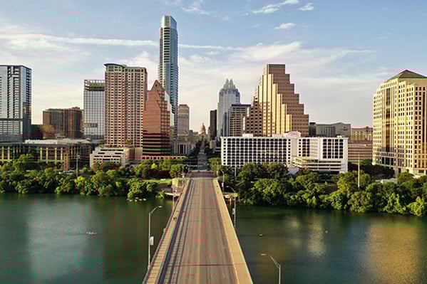 the city skyline of Austin, Texas with a bridge in the middle