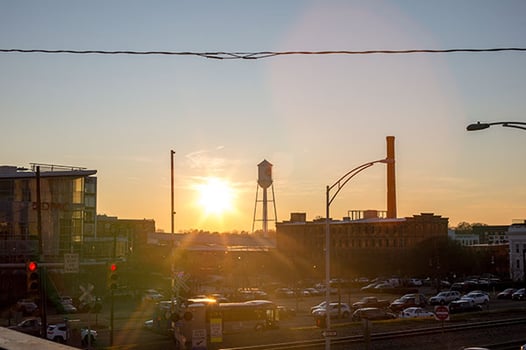 view of Durham, NC with a water tower at sunset