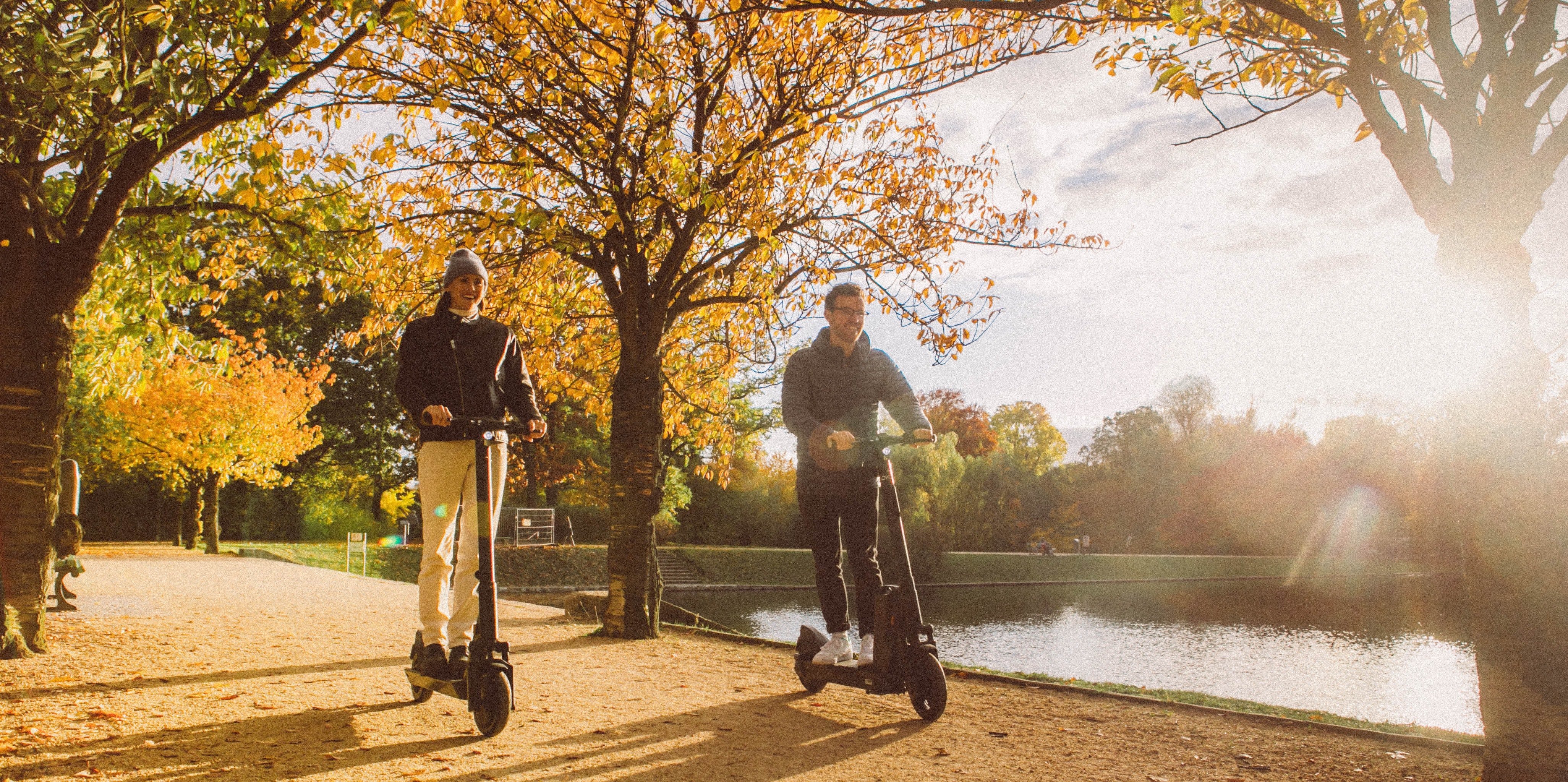 Happy folks enjoying scooters in the daylight